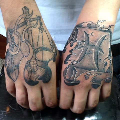 Kalat ja Vaaka - tatuointi kädessä