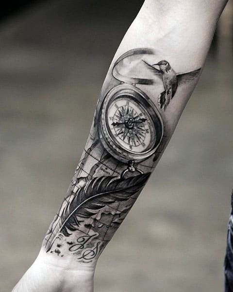 Tatuiruotės kompasas ir plunksnų paukštis po ranka
