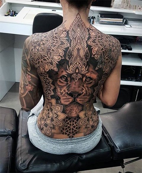 Tatovering af en løve på en piges ryg