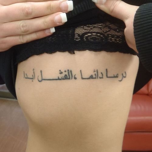 女孩肋骨上的纹身：带有翻译的铭文。草图