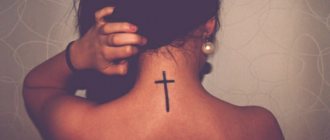 Tattoo with a cross on his back photo