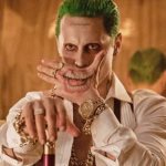 Tatoverer Jokers smil på hans arm. Skitser, foto