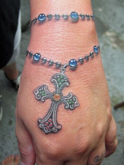 Pulseira de tatuagem na mão para raparigas. Significado da tatuagem, flor, imagem
