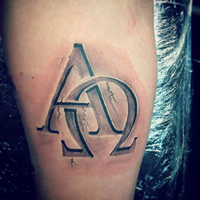Tattoo of Alpha and Omega on a Man's Leg